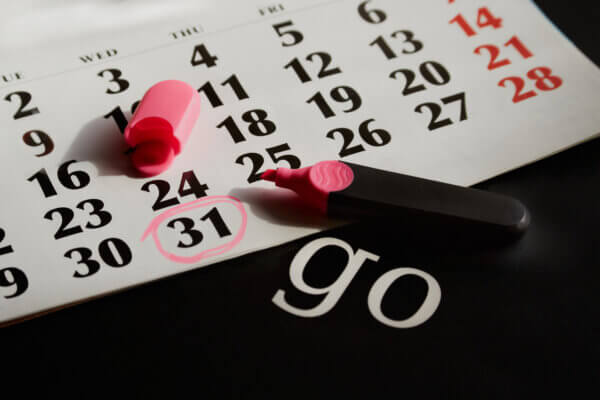 A calendar with the date 31 circled in pink marker and the word "go," symbolizing the start of a new month 