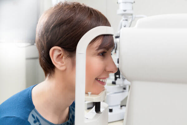 Woman having contact lens exam 