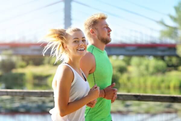 a photo of a woman jogging with a man outside 