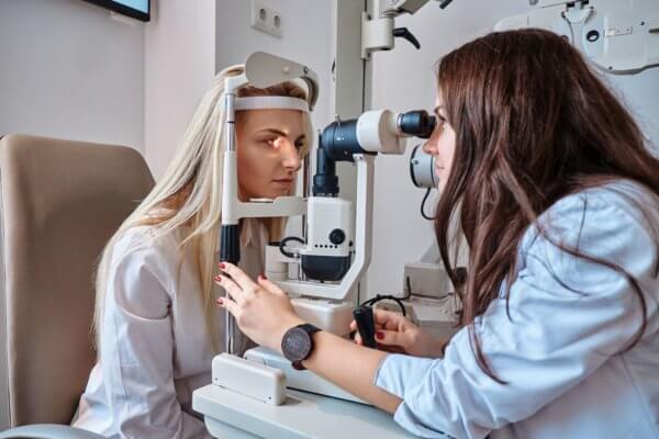 Image of woman getting her eyes tested at eye doctor.